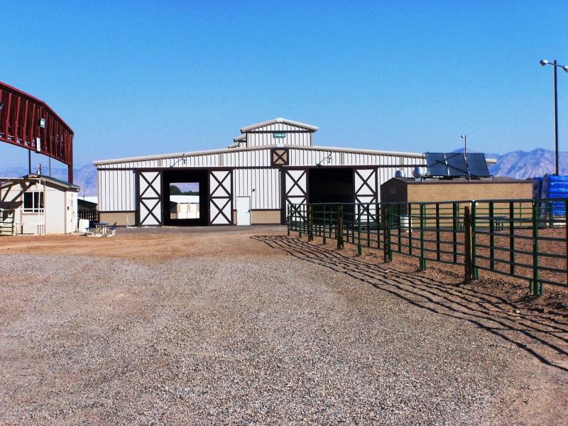 Photograph of exterior of stables with arena