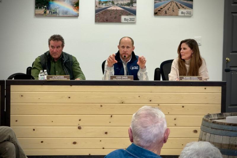 Group of people sitting at a town hall.