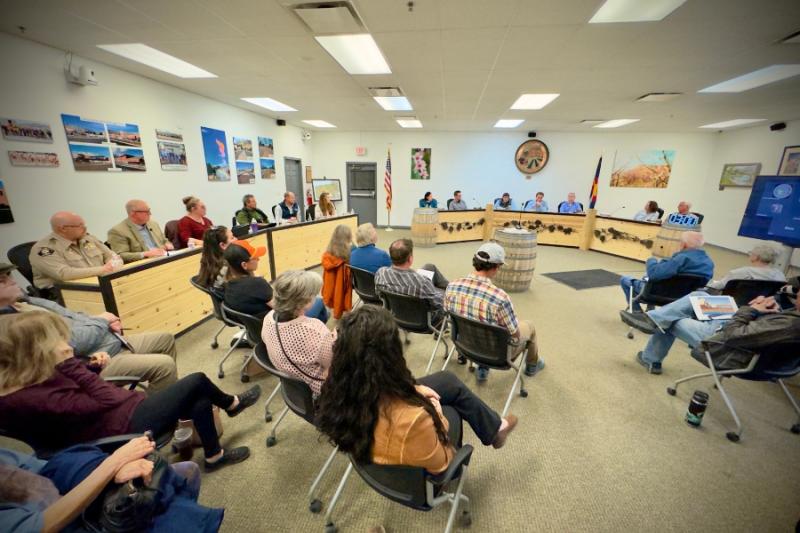 Group of people sitting at a town hall.