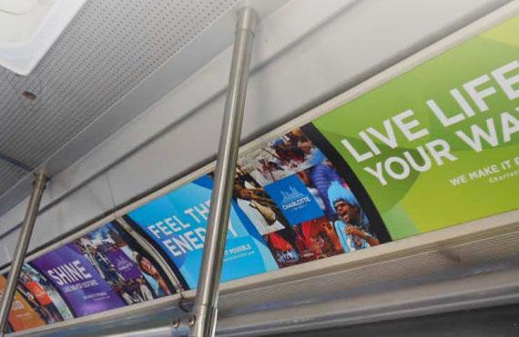 Photograph of advertising posters inside a Grand Valley Transit bus.