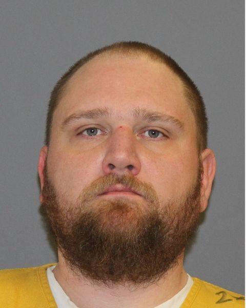 Inmate photo of Darin Thrailkill wearing a yellow jumpsuit. 