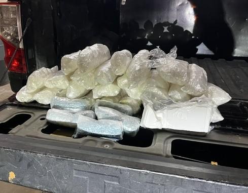 Pile of drugs in the back of a truck bed.