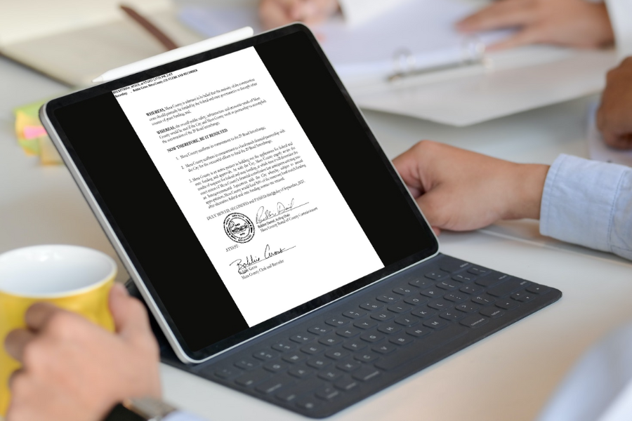 A person views a document on a laptop.