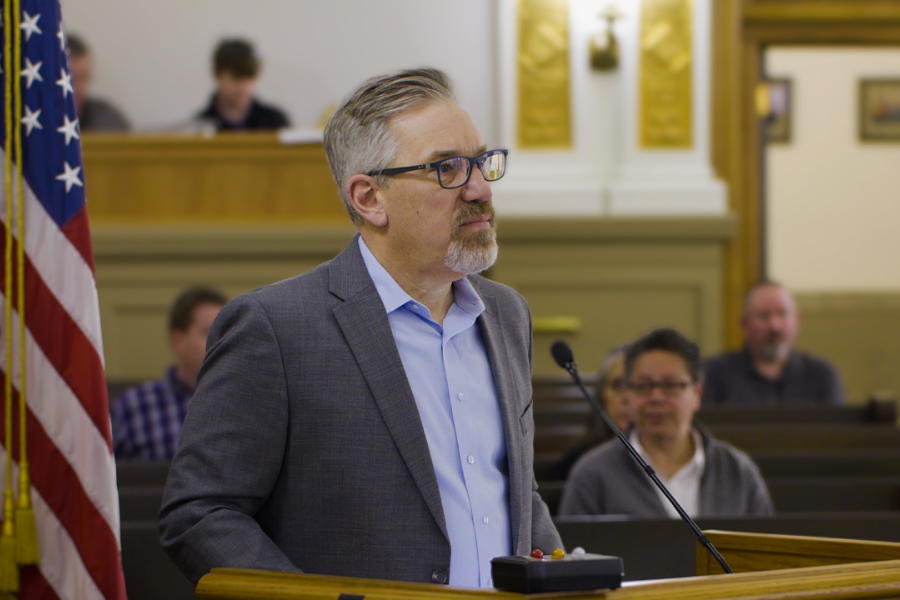 Doug Farmer, President, Colorado Health Care Association, at the podium in the public hearing room