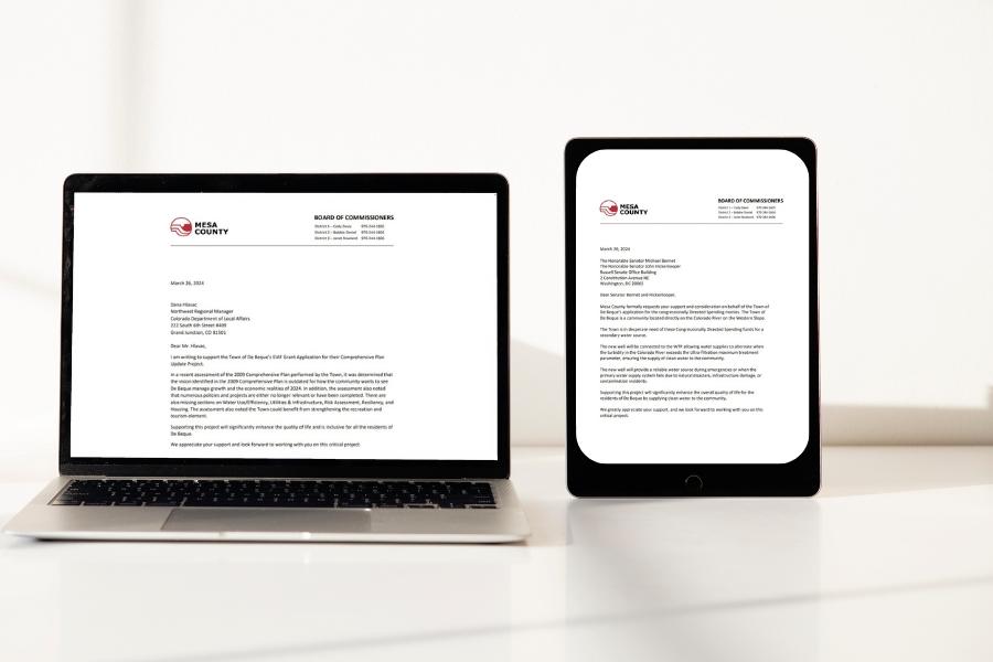 Laptop next to iPad displaying two Mesa County letters. 