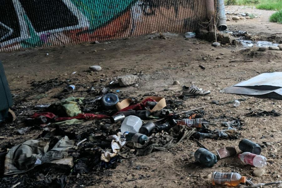 Assortment of waste on dirt under 29 Road Bridge.