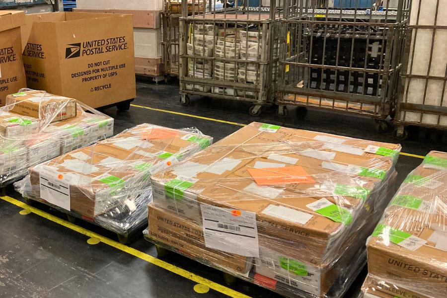 Stack of ballots packages in brown cardboard, ready to be sent out. 