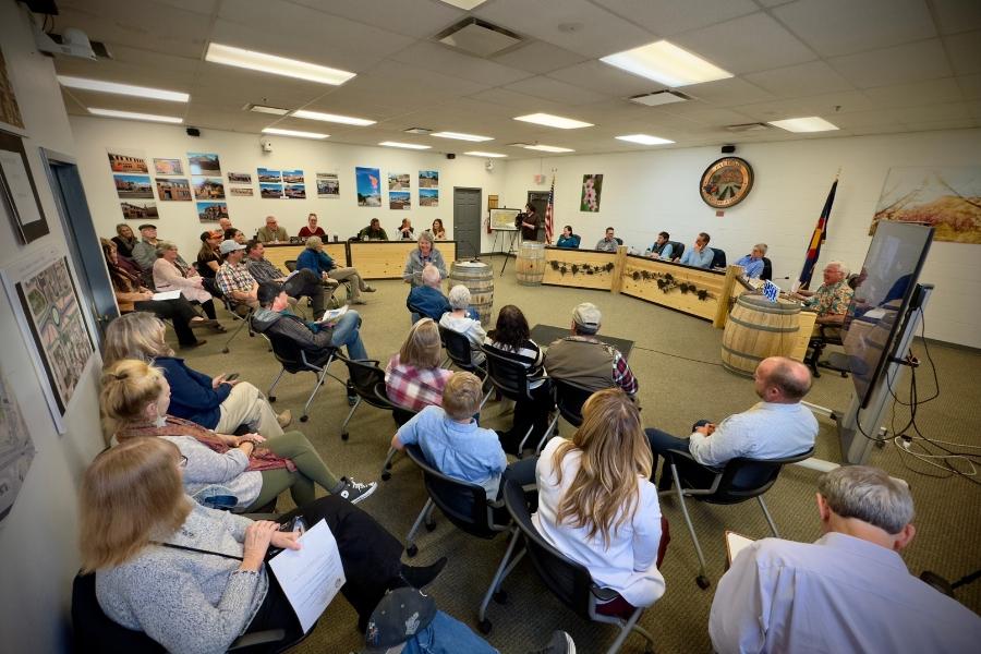 Group of people sitting at a town hall.