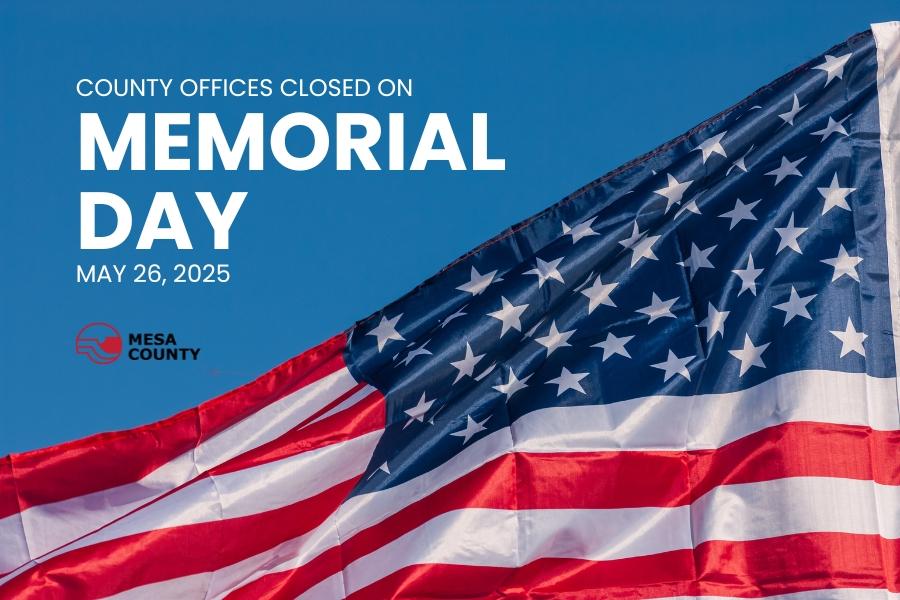 An American flag with white text above reading county offices closed on Memorial Day May 26, 2025.