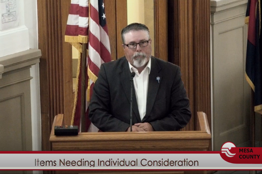 Child Welfare Director Joe Kellerby presenting behind a podium at Public Hearing.