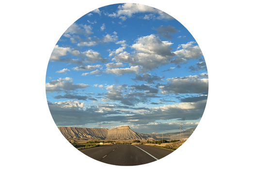 an image of I-70, with Mt. Garfield in the background and clouds in the sky