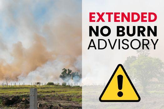 Green field with fence in the background and plumes of smoke, including a yellow alert symbol and red and black logo for Mesa County Public Health