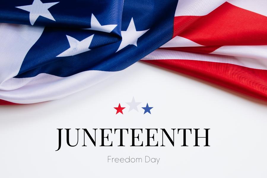 American flag with red, white, and blue stars and black text reading, Juneteenth Freedom Day.