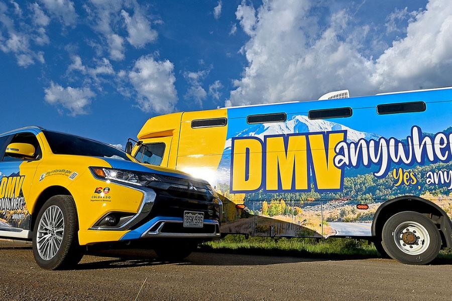 Photo of DMV2GO vehicles parked with blue sky background.