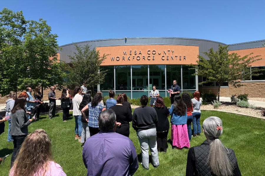 Mesa County staff gathered in front of the Workforce Center to plant flags.
