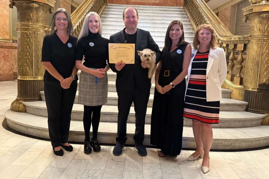 Human Services leadership poses for a photo with Governor Polis.
