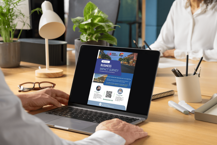 An open laptop screen showcasing a blue flyer. 