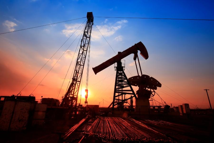 A silhouette of oil and gas equipment at sunrise. 