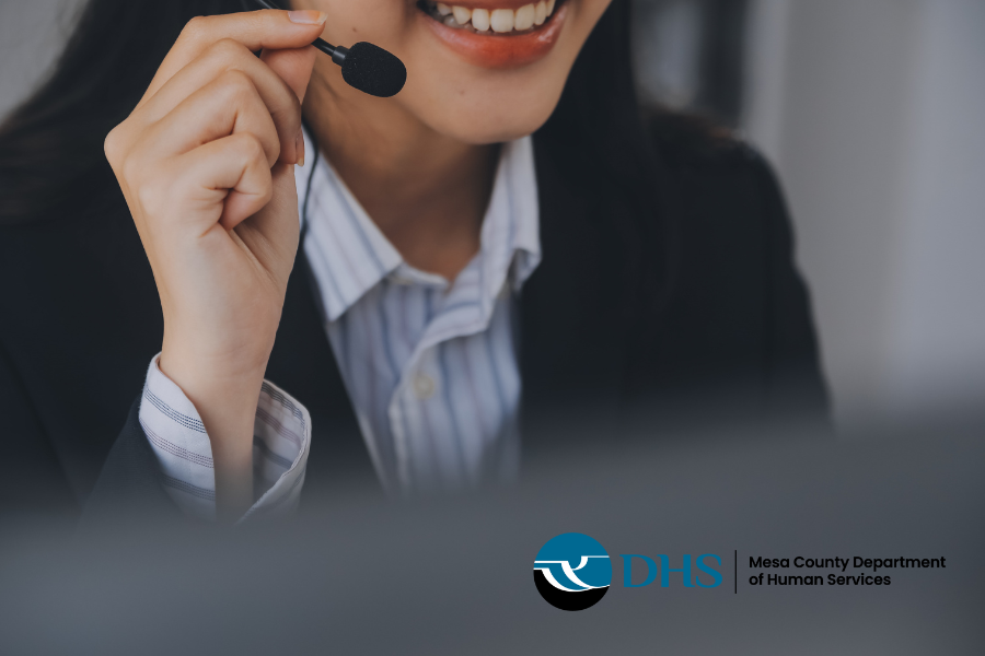 Hotline operator talking on a headset with DHS logo in the corner