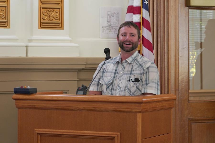 A man standing at a lectern. 