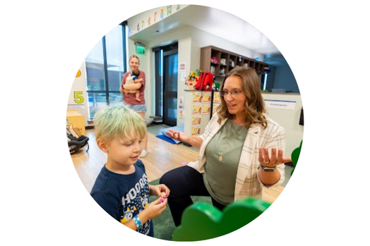 woman and child in playroom at daycare 