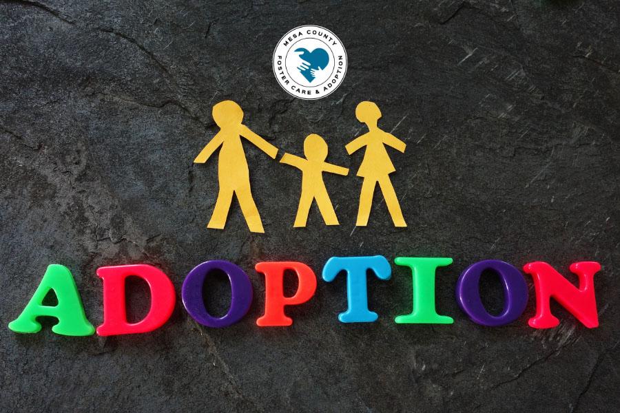 Adoption in block letters with paper cut-out family and DHS Foster Adopt logo.