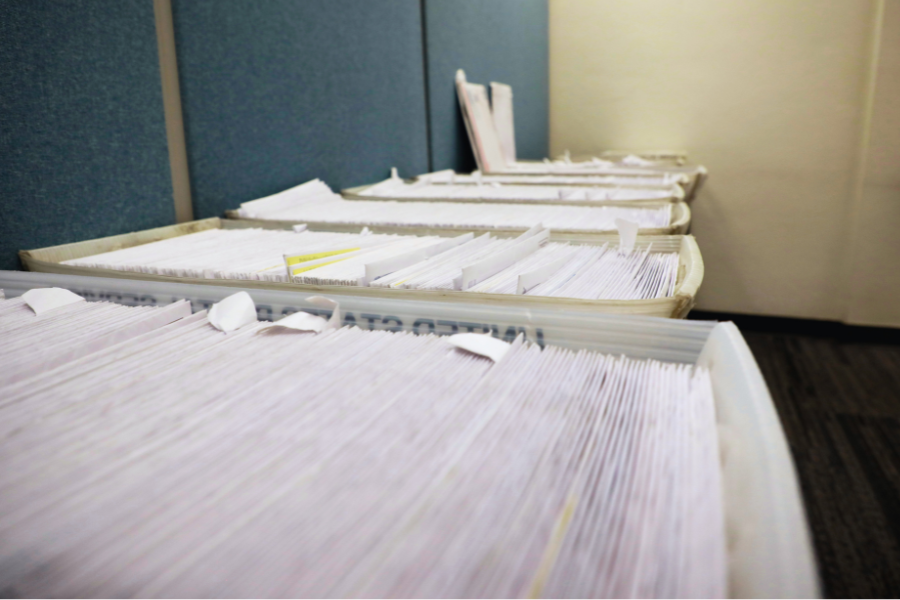 Trays of mail containing returned tax notices due to incorrect addresses.